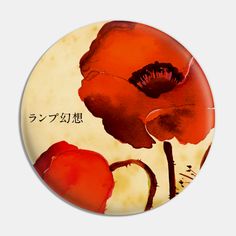 a button with an image of a red flower and japanese writing on the back side