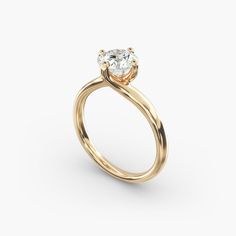 a gold engagement ring with an oval cut diamond in the center, on a white background