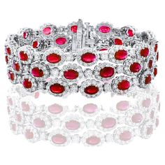 A beautiful Ruby and Diamond 3-row bracelet showcasing color-rich Rubies, surrounded by a single row of brilliant round diamonds. 42 Oval cut lush red rubies weigh 18.01 carats total; 420 accent diamonds weigh 16.44 carats total. Made in 14k white gold. Style is available in different price ranges. Prices are based on your selection. Please contact us for more information. Red Oval Tennis Bracelet Fine Jewelry, Red Oval Fine Jewelry Tennis Bracelet, Red Diamond Oval Tennis Bracelet, Red Oval Diamond Gemstone Bracelet, Red Diamond Oval Bracelet, Oval Ruby Diamond Bracelet, Red Oval Diamond Bracelet, Luxury Red Oval Bracelet, Bracelet Tennis