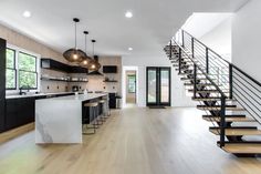 an open floor plan with stairs leading up to the kitchen