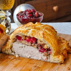 there is a meat and fruit pie on the cutting board