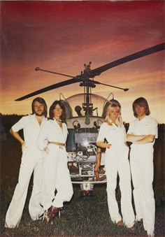 three women standing in front of a helicopter with the caption abra arrival on it