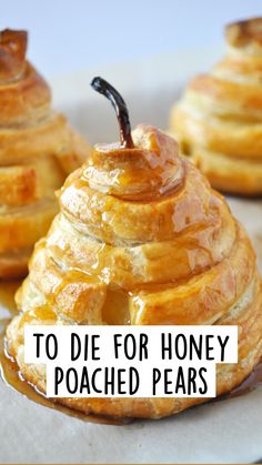 some very tasty looking desserts sitting on a tray with honey drizzled over them