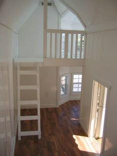 a loft with a ladder to the second floor and a window on the far side