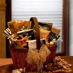 a basket filled with lots of chocolates and candies on top of a table