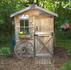 a wooden shed with a wheel attached to it