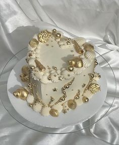 a white cake with gold decorations on it