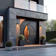 an entrance to a modern home with stone walls and large circular door, surrounded by potted plants