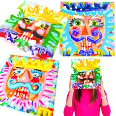 a woman holding up four colorful paintings with different faces on them and one is wearing a crown