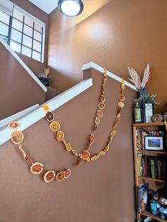 a necklace is hanging on the wall next to a bookshelf and shelves with various items