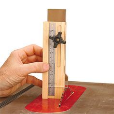 a person is holding a wooden ruler and measuring it