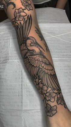 a person with a bird tattoo on their arm