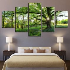 a bed room with a neatly made bed and four paintings on the wall above it