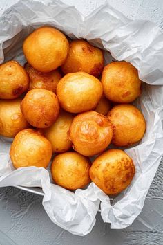 a bunch of food that is in a bag on a table with some white paper