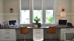 a home office with two computers on the desk