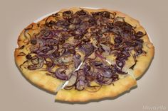 a pizza with onions on it sitting on top of a white plate