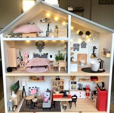 a doll house with furniture and lights on the top floor is shown in this image