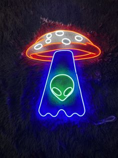 an alien sign is lit up in the dark