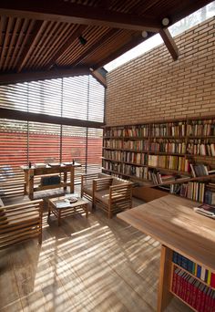 a library with wooden benches and bookshelves full of books