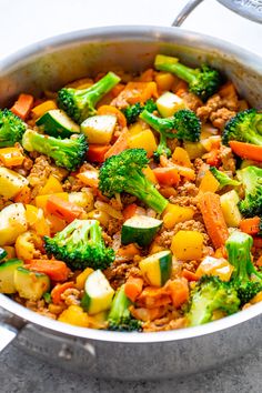 a pot filled with vegetables and meat on top of a table