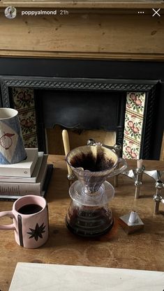 a coffee pot sitting on top of a wooden table