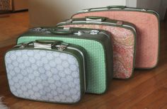 three pieces of luggage sitting on top of a wooden floor