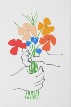 a hand holding a vase filled with colorful flowers