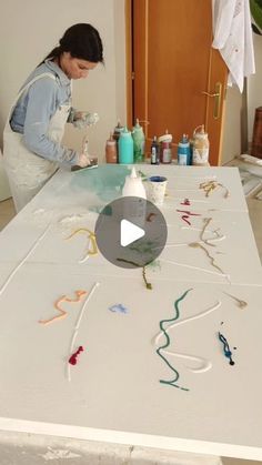 a woman is making art on a table