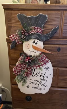 a snowman is sitting on top of a dresser