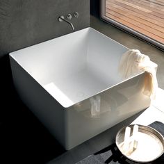 a white bath tub sitting next to a window