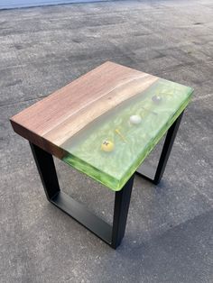 a wooden table sitting on top of a cement ground