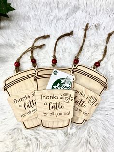 three wooden tags with thanksgiving sayings hanging from strings on a white furnishing