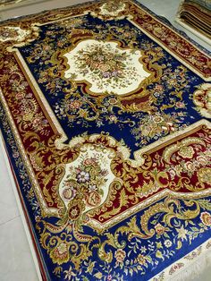 a blue and red rug is on the floor in a room with other carpeting