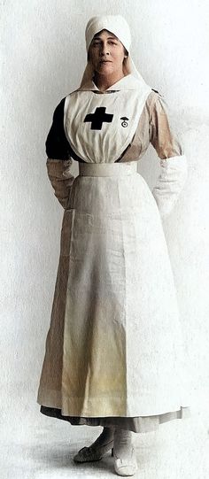 an old photo of a woman wearing a white apron and black cross on her chest