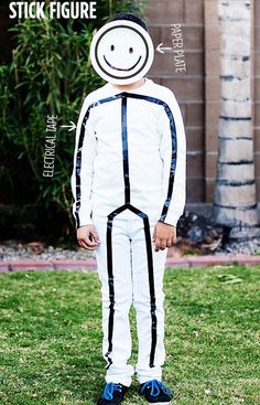 a person wearing a paper plate and tape on their face, standing in the grass