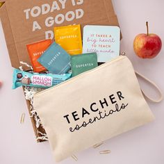 a teacher's essentials bag sitting on top of a table next to an apple