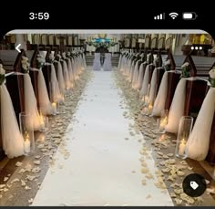 the aisle is decorated with flowers and candles