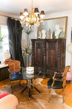 a living room filled with furniture and a chandelier