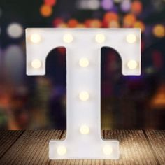 the letter t is lit up with lights