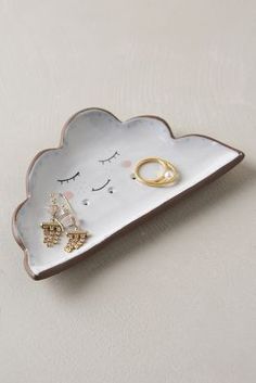 a white tray with some gold rings on it