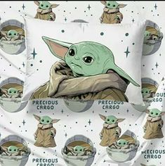 the baby yoda is sitting on top of a pillow