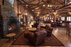 a living room filled with lots of furniture and a fire place in the middle of it