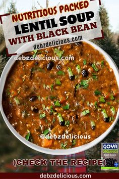 a bowl of lentil soup with black beans and green onions is shown in front of a christmas tree