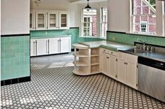 an empty kitchen with green and white walls