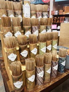 many different types of sticks are on display in a store with price tags attached to them