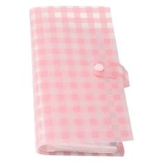 a pink and white checkered cloth with a button on the front, sitting on a white background