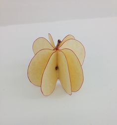 an apple cut in half sitting on top of a table