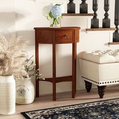 a living room scene with focus on the end table and vases in front of the stairs