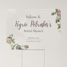 a wedding shower sign with flowers on it