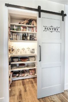 an open pantry with sliding doors on the side and shelves full of food in it